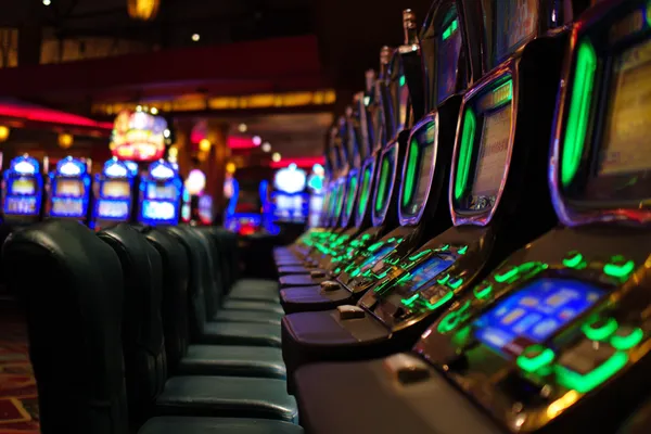 A woman in a luxurious green gown next to an ornate roulette wheel, capturing the upscale casino mood of JLWAFA88.
